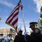 Members of the color guard carried flags during the Massachusetts Law Enforcement Memorial Annual Memorial Ceremony at the Massachusetts State House. 