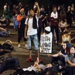 CHARLOTTE, NC - SEPTEMBER 22: Demonstrators take part in a protest on September 22, 2016 in Charlotte, NC. Protests began on Tuesday night following the fatal shooting of 43-year-old Keith Lamont Scott at an apartment complex near UNC Charlotte. A state of emergency was declared overnight in Charlotte and a midnight curfew was imposed by mayor Jennifer Roberts, to be lifted at 6 a.m. (Photo by Sean Rayford/Getty Images)