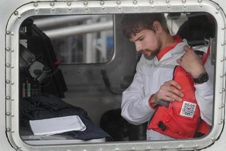 Boston, MA., 09/27/16, Nathan Carman, taking off his life preserver, is brought into the USCG Base Boston after his adventure at sea. Suzanne Kreiter\Globe staff 
