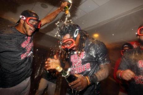 Sep 28, 2016; Bronx, NY, USA; Boston Red Sox first baseman Hanley Ramirez (13) is doused with champagne by a teammate after losing to the New York Yankees at Yankee Stadium but clinching their division with a Toronto Blue Jays loss. Mandatory Credit: Brad Penner-USA TODAY Sports
