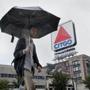 BOSTON, MA - 7/18/2016: A man walks through the rain in front of the Citgo sign at Kenmore Square. Storms moved across Massachusetts on Monday, with the entire state under a severe thunderstorm watch by the National Weather Service. (Timothy Tai for The Boston Globe)