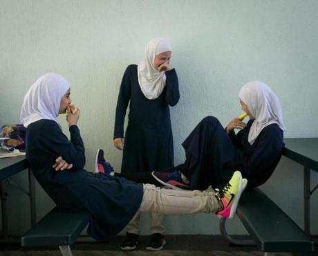 Mariam Harb, left, Ayah Elassadi, center, and Hanan Krijestorac, right, enjoyed a laugh during a lunch break at the Garden of Sahaba Academy, an Islamic school from the Islamic Center of Boca Raton.
