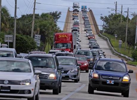 People in vehicles make an evacuation route over 520 bridge heading west from Merritt Island, Fla., Wednesday, Oct. 5, 2016, as Hurricane Matthew approaches Florida. (Red Huber/Orlando Sentinel via AP)
