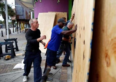 Workers install storm boards at Ripley's Movie Theater in preparation for Hurricane Matthew in Myrtle Beach, South Carolina, U.S. October 6, 2016. REUTERS/Randall Hill
