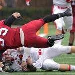 Cambridge, MA - 10/08/2016 - Cornell Big Red quarterback Dalton Banks (7) scrambled out of the pocket and is brought down by Harvard Crimson linebacker Luke Hutton (35) during the first half. Harvard hosts Cornell in Ivy League football. - (Barry Chin/Globe Staff), Section: Sports, Reporter: Michael Everett Cooke, Topic: 09Harvard-Cornell, LOID: 8.3.247044399.