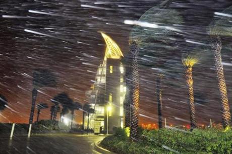 Trees sway from heavy rain and wind from Hurricane Matthew in front of Exploration Tower early Friday, Oct. 7, 2016 in Cape Canaveral, Fla. Matthew weakened slightly to a Category 3 storm with maximum sustained winds near 120 mph, but the U.S. National Hurricane Center says it's expected to remain a powerful hurricane as it moves closer to the coast. (Craig Rubadoux/Florida Today via AP)
