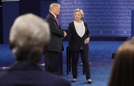Chelsea Clinton (right) and former President Bill Clinton (left) watched as Republican as Donald Trump and Hillary Clinton shook hands
