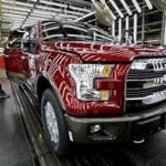 A worker inspects an aluminum-alloy body Ford F-150 truck at the company?s plant in Claycomo, Mo., in 2015.