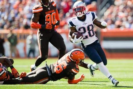 CLEVELAND, OH - OCTOBER 9: Inside linebacker Demario Davis #56 of the Cleveland Browns tries to tackle running back James White #28 of the New England Patriots during the first half at FirstEnergy Stadium on October 9, 2016 in Cleveland, Ohio. (Photo by Jason Miller/Getty Images)
