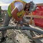 Kevin Rineer working on a cement hose at the construction site of the Wynn Casino in Everett (above). 