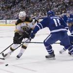 Bruins forward David Krejci (left) tried to slip the puck past Toronto?s Zach Hyman and Nikita Zaitsev in the first period.