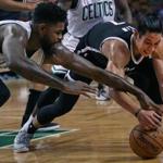 The Celtics? Amir Johnson (left) battled the Nets? Jeremy Lin for a loose ball in the first quarter.