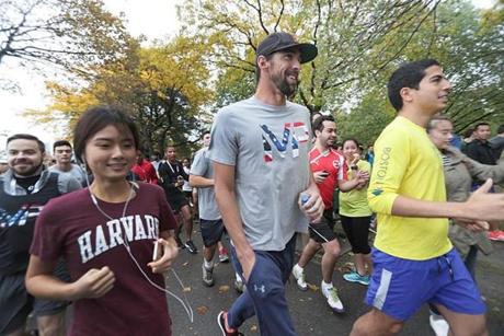 Boston, MA., 10/18/16, Olympian Michael Phelps lead a morning run, with participants of the Forbes Under 30 Summit, starting at the Hatch Shell and continuing along the Charles River to the Massachusetts Avenue bridge. The run is being co-organized with the Pan-Mass Challenge. Globe staff/ Suzanne Kreiter
