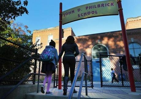 Janelle Smith arrived with daughter Alorah Miles, 9, at Philbrick Elementary in Roslindale, her school for now. 
