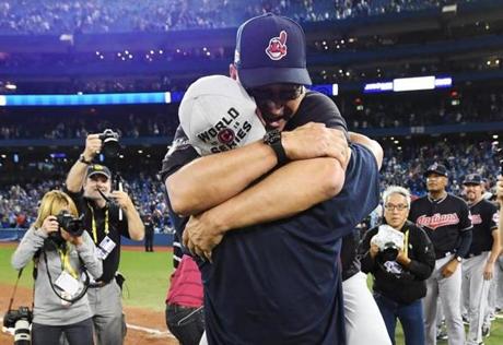 Cleveland Indians manager Terry Francona jumps into the arms of designated hitter Mike Napoli as they celebrate after the Indians defeated the Toronto Blue Jays 3-0 during Game 5 of the baseball American League Championship Series, in Toronto on Wednesday, Oct. 19, 2016. (Frank Gunn/The Canadian Press via AP)
