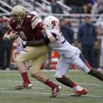 Boston College quarterback Patrick Towles (8) is wrapped up by Syracuse linebacker Parris Bennett (30) during the first half of an NCAA college football game, Saturday, Oct. 22, 2016, in Boston. (AP Photo/Mary Schwalm)