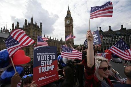 Activists waved US flags as they ride on a ?Stop Trump? battle bus as they approached the Houses of Parliament in London in September. 
