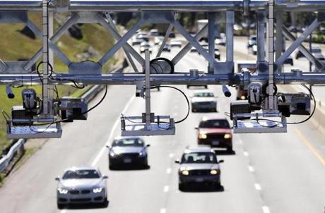 Cars pass under toll sensor gantries hanging over the Massachusetts Turnpike, Monday, Aug. 22, 2016, in Newton, Mass. The state Department of Transportation is discussing plans for demolishing the tollbooths as it gets ready to implement an all-electronic tolling system on Interstate 90 which runs the length of the state. (AP Photo/Elise Amendola)
