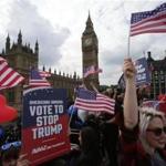 Activists waved US flags as they ride on a ?Stop Trump? battle bus as they approached the Houses of Parliament in London in September. 