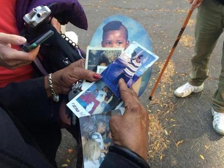 Hope Coleman held photos of her son Terrence, who was fatally shot Sunday.
