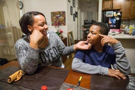 Angelo Jones talked with his mother, Janeé, at their home in Brighton. Angelo recently transferred to Davis Leadership Academy.
