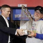 Nov 2, 2016; Cleveland, OH, USA; Chicago Cubs president Theo Epstein passes the commissioner's trophy to manager Joe Maddon (70) after game seven of the 2016 World Series against the Cleveland Indians at Progressive Field. Mandatory Credit: David J. Phillip/Pool Photo via USA TODAY Sports
