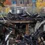 Debris sits piled up at the site of a fire of a home occupied by squatters that killed one person in Boston.