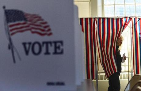 Cathy Nilsen pulled the curtain back as she left the voting booth in N.H.
