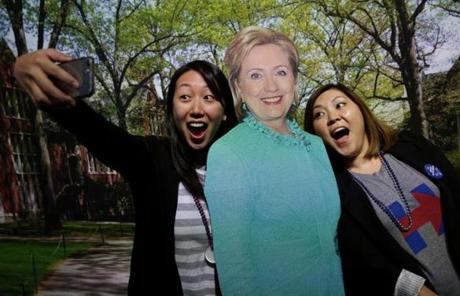 Wellesley, MA - November 08, 2016: Wellesley College alums (both class of 2006) Leslie Kim (cq) , left and Jennifer Shin (cq) make a selfie with a cutout of Hillary Clinton during an Election Night watch party at the Dorothy Town Field House at Wellesley College in Wellesley on November 08, 2016. Students, alums, and women of all ages gathered at Hillary Clinton's alma mater to await election results. (Craig F. Walker/The Boston Globe) Section: Metro reporter: 
