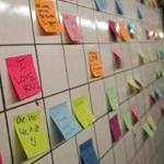 Notes, many with politically themed messages, hang on a wall at the 6th Avenue subway station. 