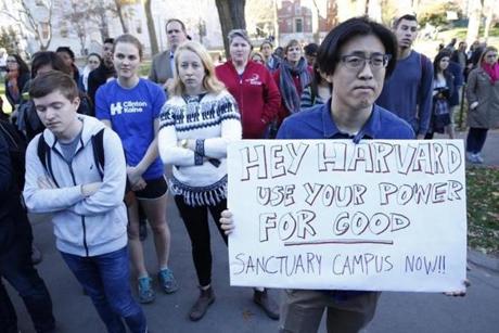 Harvard Law School student David Kim held a sign as he took part in a rally to show support for undocumented students.
