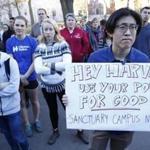Harvard Law School student David Kim held a sign as he took part in a rally to show support for undocumented students.