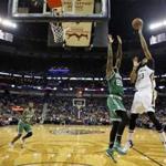 Amir Johnson (90) and the Celtics had a tough time defending Pelicans star Anthony Davis (right), who had 25 points.