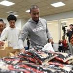 Isaiah Thomas and young people from the Bridging the Gap program assembled family food kits at the Celtics practice facility in Waltham.