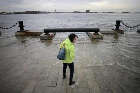 Boston, MA - 11/15/16 - Lynda DeBiccari wades in as the water rises during a King Tide at the end of Long Wharf. (Lane Turner/Globe Staff) Reporter: (in caps) Topic: ()
