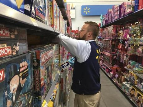 Denver Wal-Mart Supercenter employee Aaron Sanford stocks toys on shelves, Wednesday, Nov. 23, 2016, to prepare for a Thanksgiving night rush that kicks off this year's Black Friday weekend. Sanford and his colleagues anticipate hundreds will line up Thursday and thousands will come through the doors on Friday in search of bargains on toys and electronics. (AP Photo/Jim Anderson)
