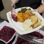 Volunteers serve a traditional Thanksgiving meal during the 