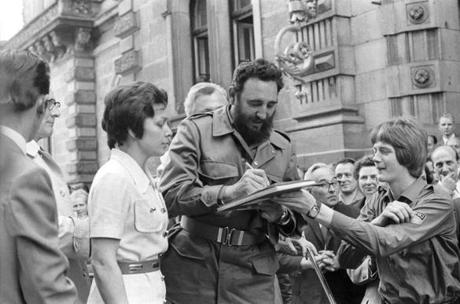 FILE - In this June 1972 file photo, Cuba's leader Fidel Castro autographs a book during his visit to East Berlin in the former German Democratic Republic. Castro has died at age 90. President Raul Castro said on state television that his older brother died late Friday, Nov. 25, 2016. (Prensa Latina via AP Images/Rogelio More, File)
