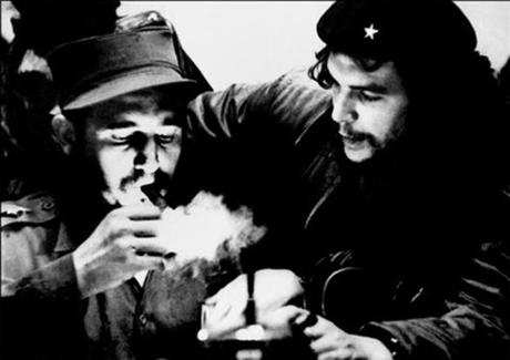 (FILES) This file photo taken in the 1960s shows then Cuban Prime Minister Fidel Castro (L) lighting a cigar while listens Argentine Ernesto Che Guevara. Cuban revolutionary icon Fidel Castro died late on November 25, 2016 in Havana, his brother, President Raul Castro, announced on national television. / AFP PHOTO / CUBADEBATE / Roberto SALASROBERTO SALAS/AFP/Getty Images
