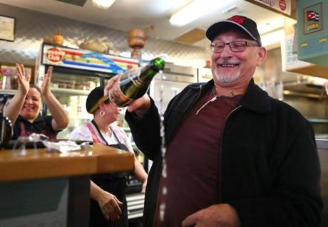 Boston-11/26/2016- Nobel Garcia, owner of the El Oriental de Cuba restaurant celebrated by opening a 20-year-old bottle of sprarkling apple cider with the words: 