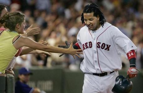 8/10/2005:Boston,MA: GLOBE STAFF PHOTO/JIM DAVIS:Red Sox LF Manny Ramirez gets a hand from a front row fan as he heads for the dugout following his fourth inning home run. Library Tag 08112005 Sports
