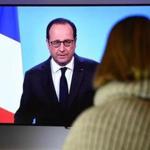 A person watched French President Francois Hollande announce he would not seek a second term on Thursday.
