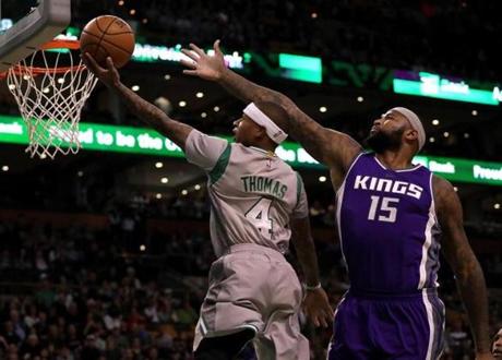 Boston, MA - 12/02/2016 - (1st quarter) Boston Celtics guard Isaiah Thomas (4) drives up and under the outstretched arms of Sacramento Kings center DeMarcus Cousins (15) for a first quarter layup. The Boston Celtics take on the Sacramento Kings at TD Garden. - (Barry Chin/Globe Staff), Section: Sports, Reporter: Adam Himmelsbach, Topic: 03Celtics-Kings, LOID: 8.3.852505292.
