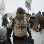 Despite blizzard conditions, military veterans who say they support the pipeline protesters marched Monday near the Standing Rock Sioux Reservation.