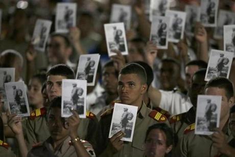 Military cadets hold pictures of Fidel Castro during a rally at the Revolution Plaza in Havana, Cuba, Tuesday, Nov. 29, 2016. Regional leaders and tens of thousands of Cubans filled Havana's Plaza of the Revolution Tuesday night for a service honoring Fidel Castro on the wide plaza where the Cuban leader delivered fiery speeches to mammoth crowds in the years after he seized power. Fidel Castro passed away Friday Nov. 25. He was 90.(AP Photo/Ricardo Mazalan)
