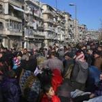Syrians fleeing the violence in Aleppo gathered at a checkpoint Thursday manned by progovernment forces in the city.