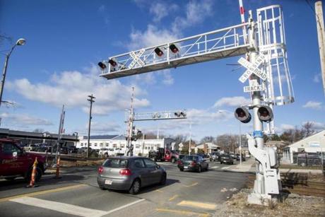 Cars at a commuter rail crossing on Brighton St. in Belmont on Friday, December 9, 2016. A commuter train hit a car earlier at the crossing. (Scott Eisen for The Boston Globe)
