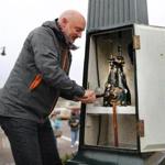 Dorchester-12/07/2016- Every week Jeffrey Gonyeau has to wind the clock that stands in Peabody Square in Dorchester. He has done this for more than a decade, using a hand crank to turn the old mechanism inside. John Tlumacki/Globe Staff (metro)