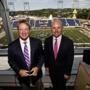 ESPN Monday Night Football announcers Jon Gruden, left, and Sean McDonough stand in the press box of Tom Benson Hall of Fame Stadium before a preseason NFL football game between the Green Bay Packers and the Indianapolis Colts,Sunday, Aug. 7, 2016, in Canton, Ohio. (AP Photo/Gene Puskar)