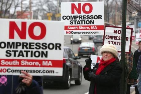 Weymouth, MA - 12/07/2016 -- Regina Potter (cq), of North Weymouth, and others hold signs at the entrance to the Fore River Bridge, in Weymouth. They are opposed to the proposed construction of a gas compressing station nearby. Photo by Pat Greenhouse/Globe Staff TOPIC: weymouth Reporter: Michael Levenson
